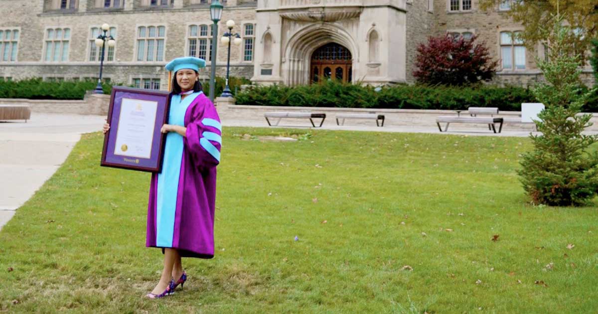 Ranabelle Stroh poses for a photo on UC Hill shortly after convocation