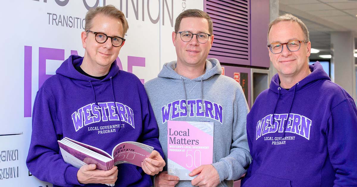 Zack Taylor, Joe Lyons, Martin Horak hold copies of the 