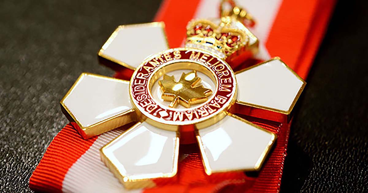 The insignia of the Order of Canada is a snowflake with six points and a stylized maple leaf at its centre, containing the motto “they desire a better country” in Latin.