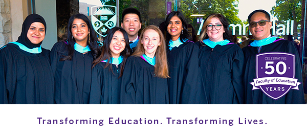 Several alumni smile at the camera. They are dressed in Faculty of Education robes and are standing in front of Alumni Hall.