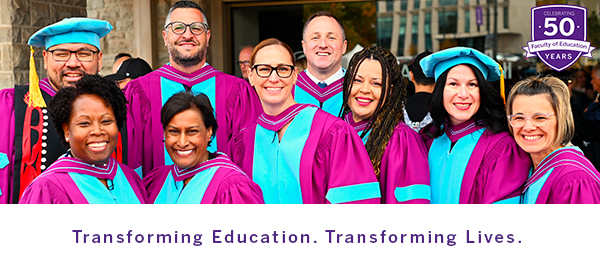 A photo of several EdD graduates standing in front of Alumni Hall.