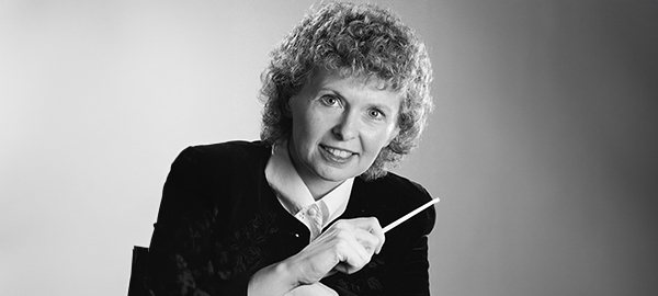 Headshot of Nancy Telfer holding a baton