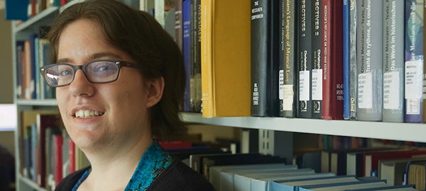 Photo of Kristin Franseen standing in front of books