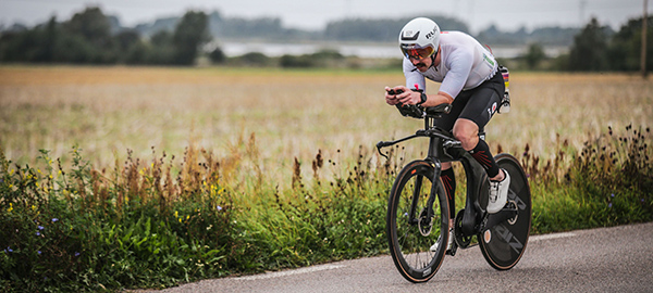 Blair Hennessey rides a racing bike along a field