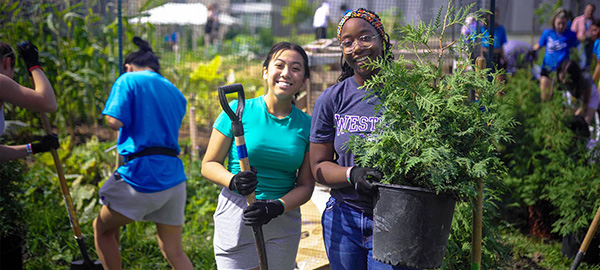 Students prepare to plant trees as part of orientation activities in 2022