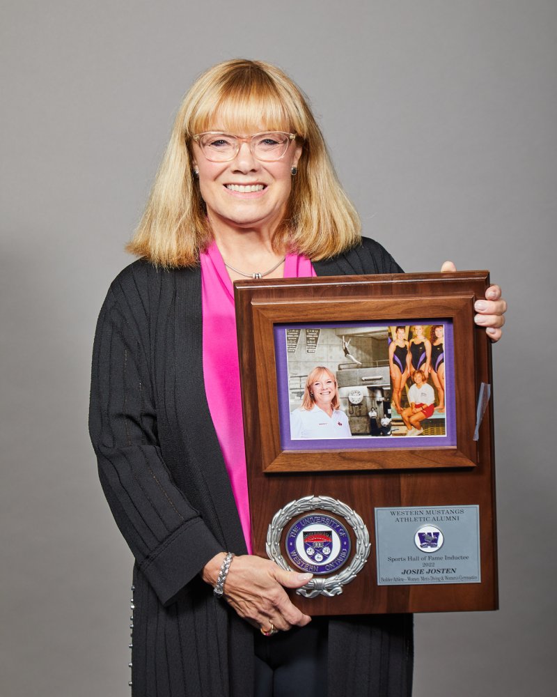 Josie Josten holding her WMAA Hall of Fame Inductee plaque