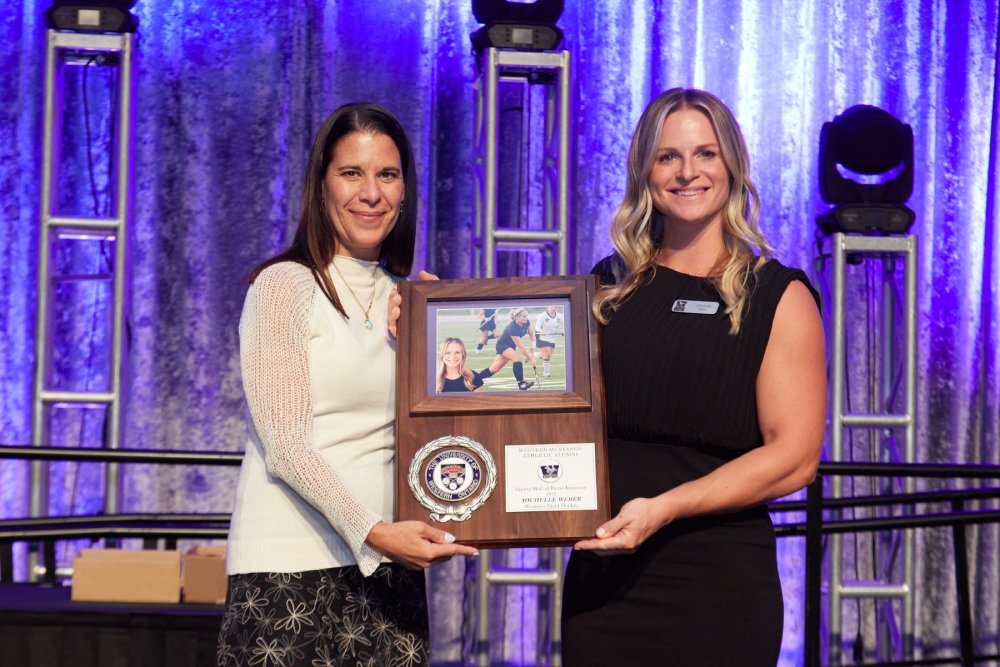 Michelle Weber receiving her WMAA Hall of Fame Inductee plaque from Sherri Castrilli