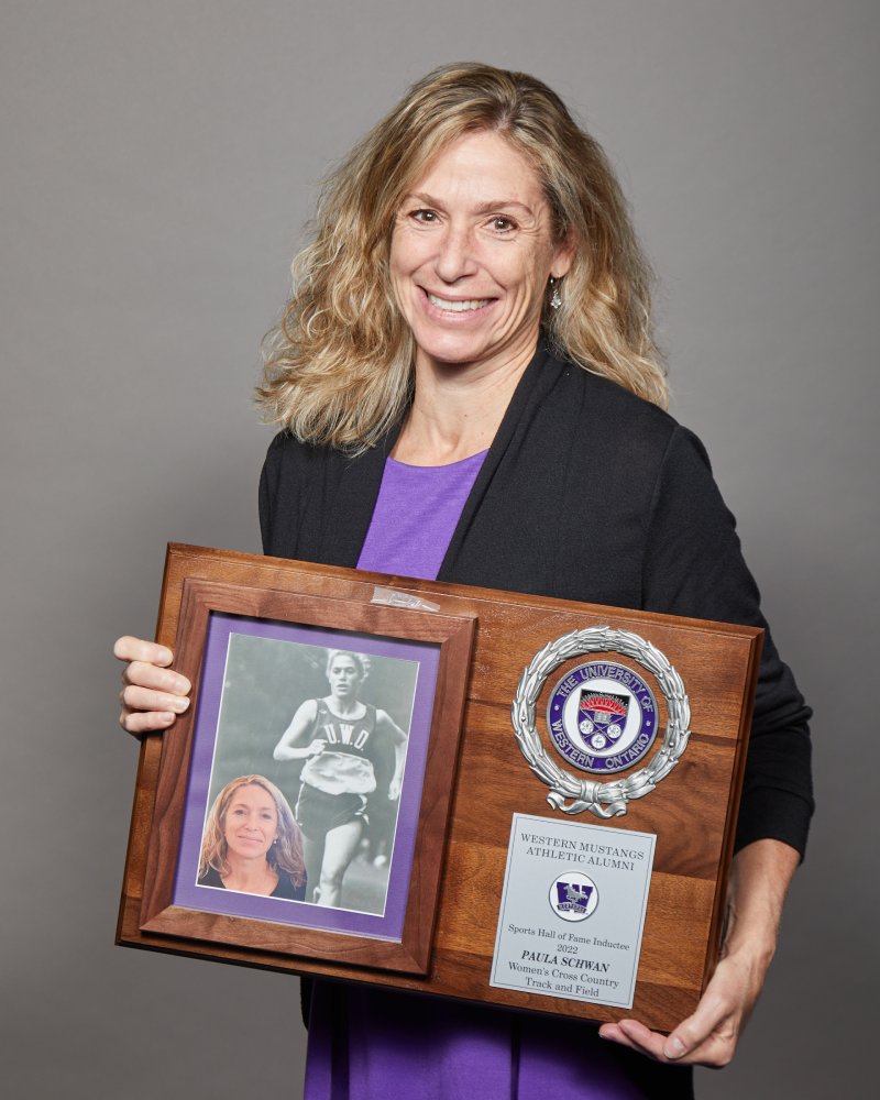 Paula Schwan holding her WMAA Hall of Fame Inductee plaque