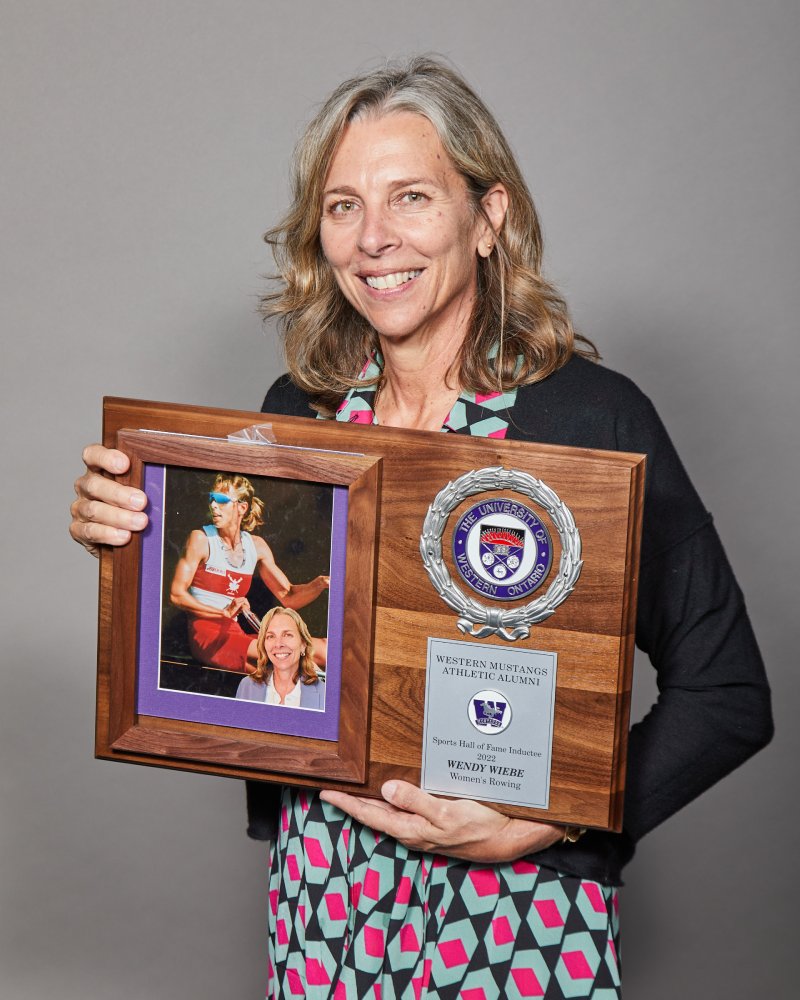 Wendy Wiebe holding her WMAA Hall of Fame Inductee plaque