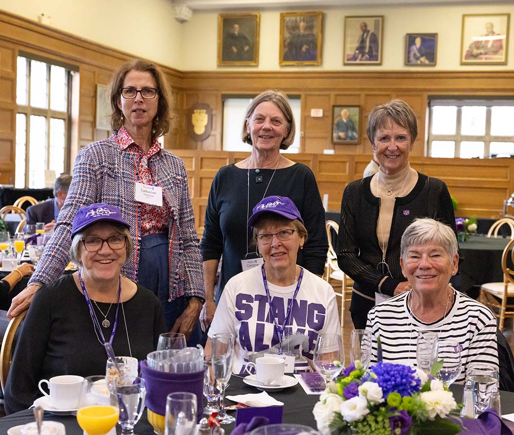 alumni pose for a photo