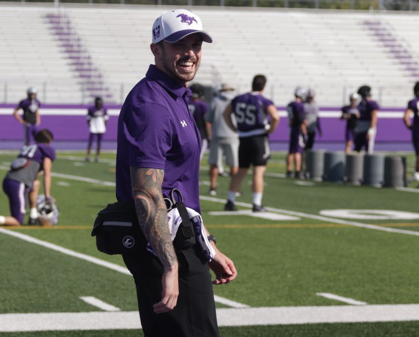 Western physiotherapy grad Blair Hennessey working with the Western Mustangs football team.