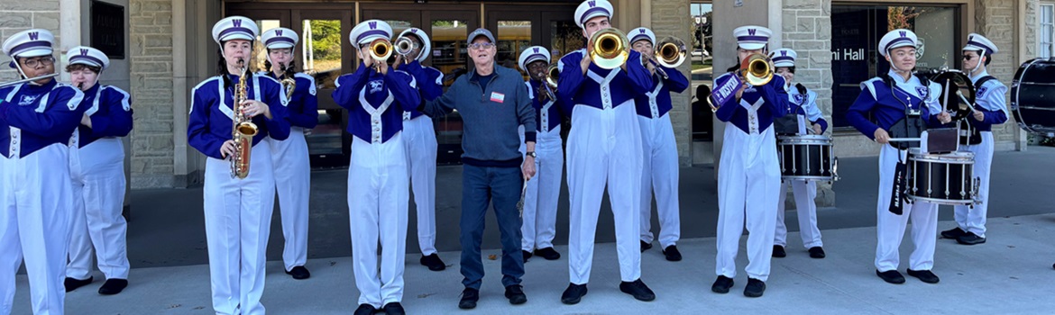 Western geography alum Alex Sikorski with the Western Mustangs marching band during the class's 2024 reunion.