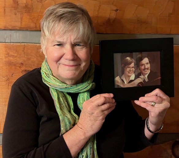 Terry Green holds a graduation photo of she and her husband Hugh Fraser.